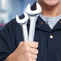 service technician holding up wrenches