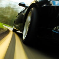 close up of car driving away on road